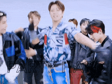 a group of young men are dancing in a room with the words party hard written on the screen .