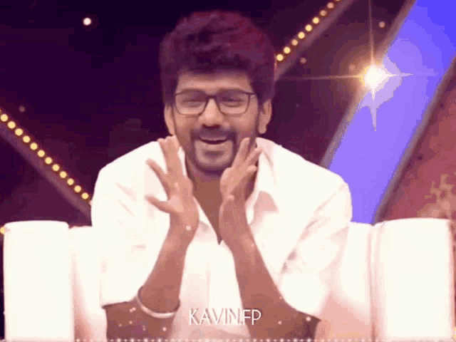 a man wearing glasses and a white shirt says kavinfp on the bottom