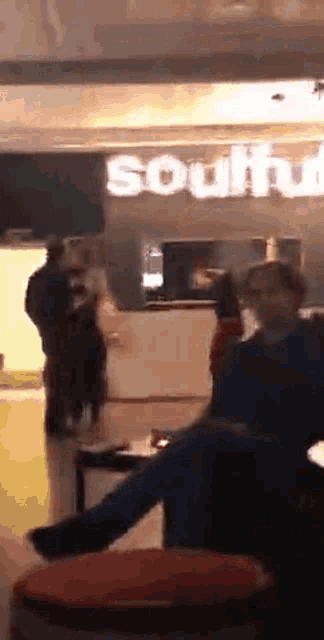 a group of people are sitting in front of a southwest restaurant