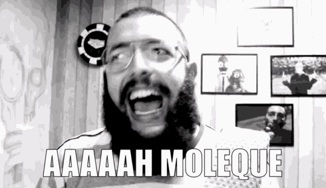 a man with a beard and glasses is screaming with the words aaaah moleque written below him