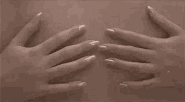 a woman 's hands are touching her breasts .