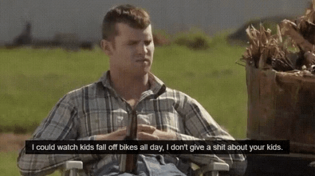 a man in a plaid shirt is sitting in a chair with the words i could watch kids fall off bikes