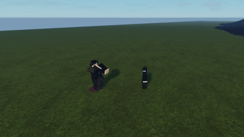 a man in a black suit is standing in a grassy field next to a skateboard