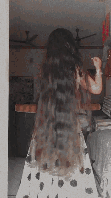 a woman with very long hair wearing a white dress