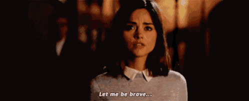 a woman is standing in a dark room and says `` let me be brave ... ''