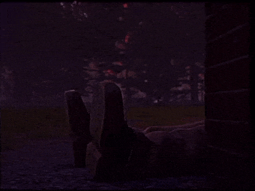 a dinosaur is standing in front of a brick wall