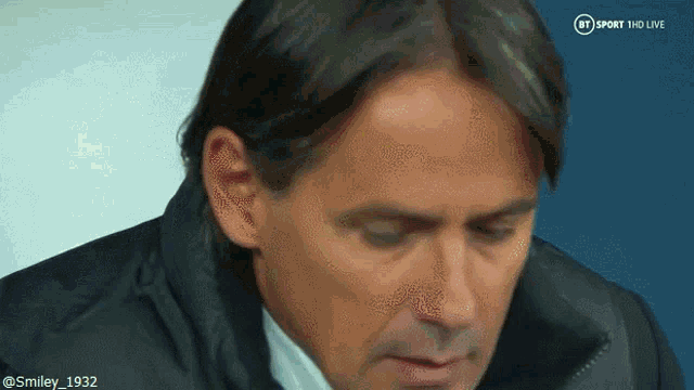 a close up of a man 's face with a bt sport logo in the corner