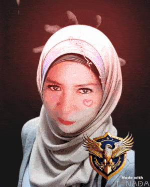 a woman wearing a white hijab has a heart painted on her cheek