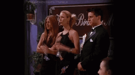 a man and a woman are standing next to each other at a party .