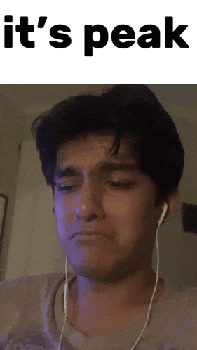 a young man wearing ear buds is crying with the words it 's peak behind him