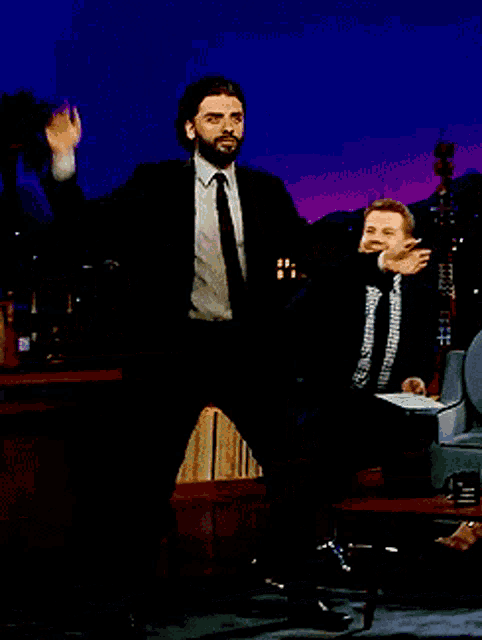 a man in a suit and tie is dancing