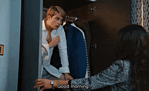 a man and a woman are standing in a closet and the woman says good morning