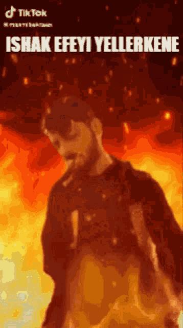 a man with a beard is smoking a cigarette in front of a fire .