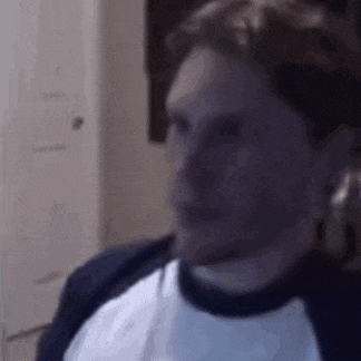 a close up of a man 's face in a room .