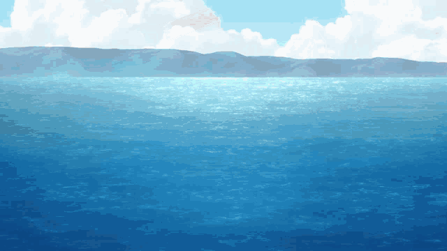 a large body of water with mountains in the distance