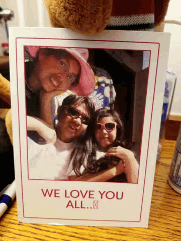 a card that says we love you all is on a table