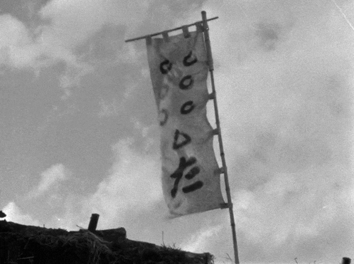 a black and white photo of a banner with chinese writing