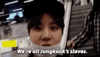 a young man wearing a mask and a hat is talking about jungkook 's slaves .