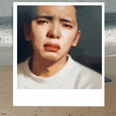 a painting of a man 's face with a beach in the background