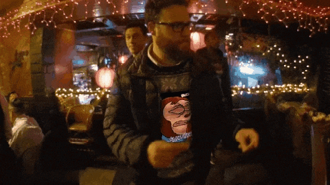 a man wearing a sweater that has a picture of a cartoon character on it