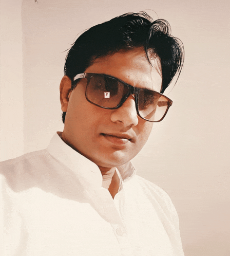 a man wearing sunglasses and a white shirt has a sticker on his face that says ' a '