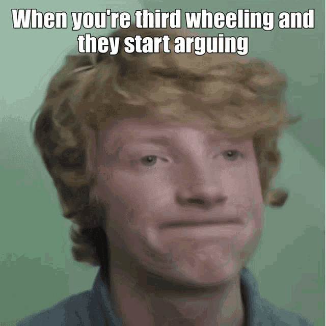 a man with red hair is making a funny face with the caption when you 're third wheeling and they start arguing