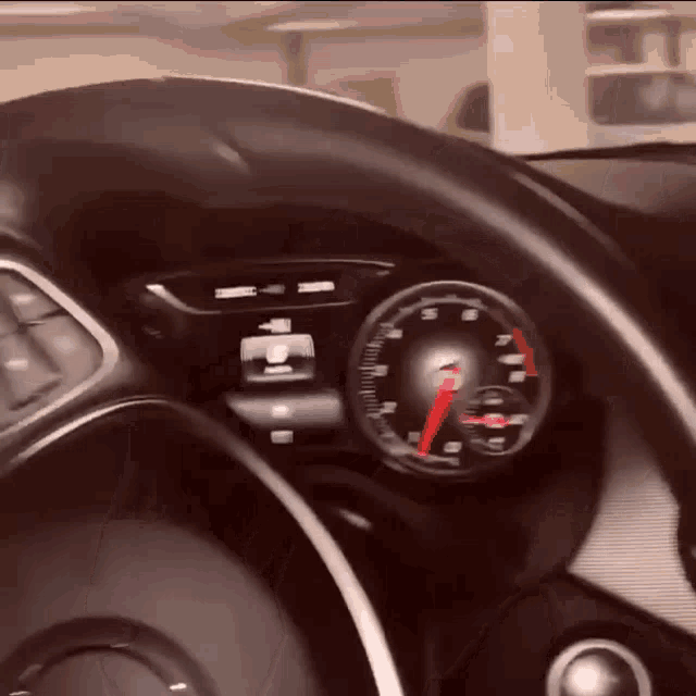 a close up of a car 's dashboard with a speedometer showing a maximum speed of 70 mph