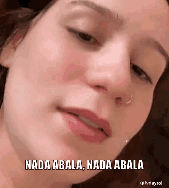 a close up of a woman 's face with a caption that says nada abala