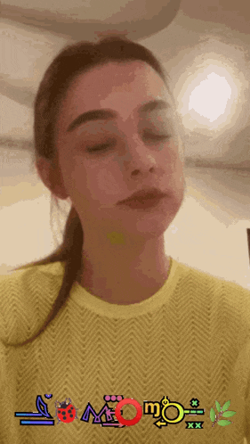 a woman wearing a yellow shirt that says momo xxx