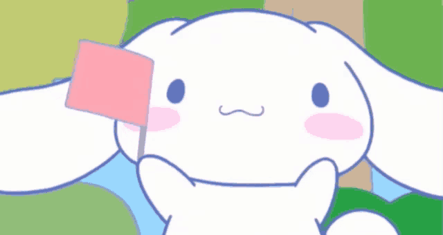 a white rabbit with a pink square on its ear is smiling