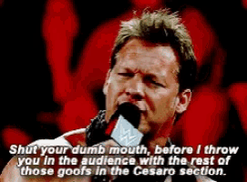 a man speaking into a microphone with a caption that says shut your dumb mouth before i throw you in the audience