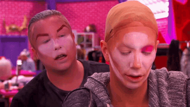 a man and a woman with makeup on their faces .