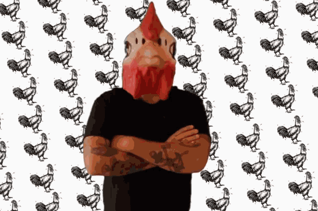 a man wearing a rooster mask stands with his arms crossed in front of a pattern of roosters
