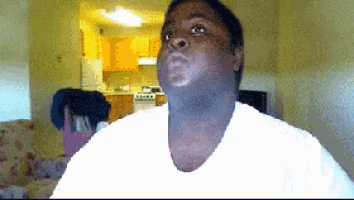 a man in a white shirt is looking at the camera