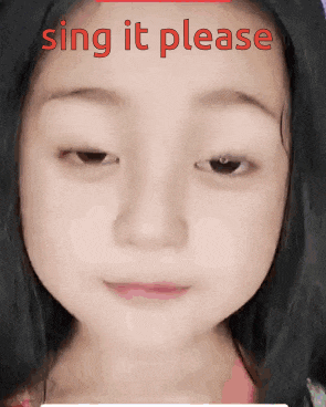 a little girl is making a funny face and singing it please