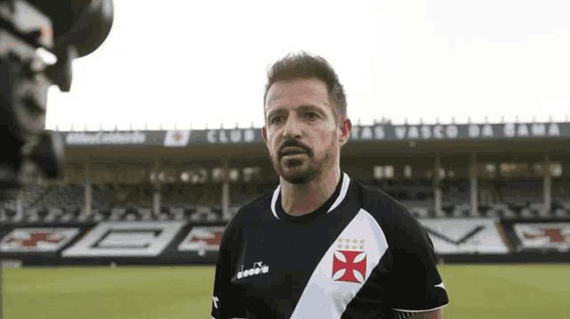 a man with a beard wearing a vasco da gama jersey