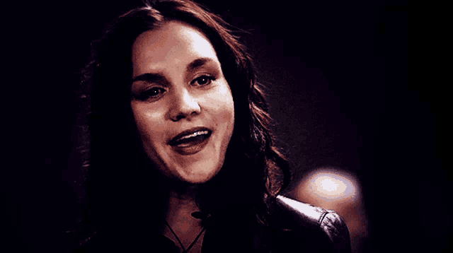 a close up of a woman 's face with a smile on her face