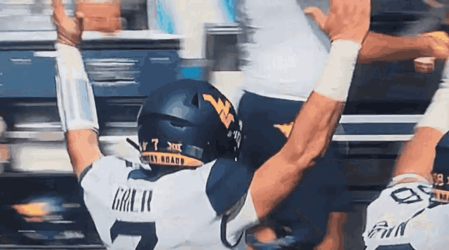 a football player with the number 7 on his back is being tackled