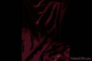 a close up of a statue of a demon on a wall .