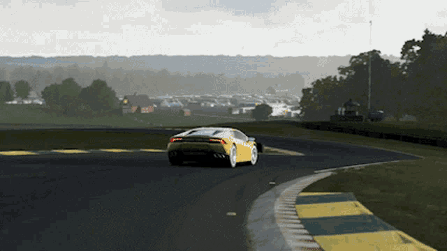 a yellow lamborghini is driving on a race track
