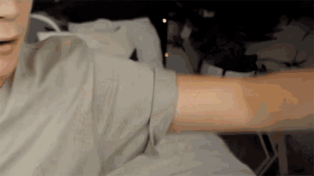 a close up of a person 's arm with a blurry background