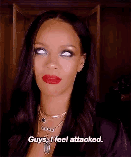 a woman with red lipstick is making a funny face and saying `` guys , i feel attacked . ``