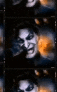 a close up of a man 's face with a joker face on it