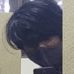 a man is taking a picture of himself in a mirror .