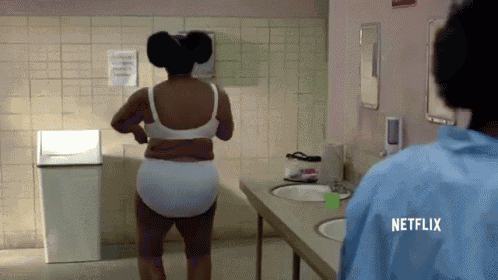 a woman in underwear is standing in a bathroom with a netflix logo on her back