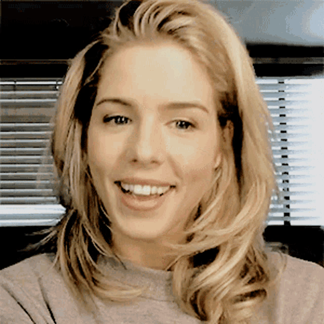 a close up of a woman 's face with a smile on her face