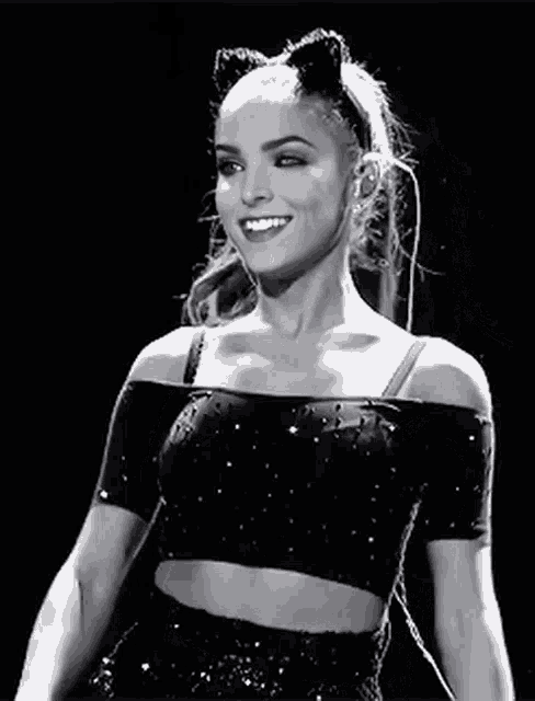 a black and white photo of a woman wearing a cat ear headband