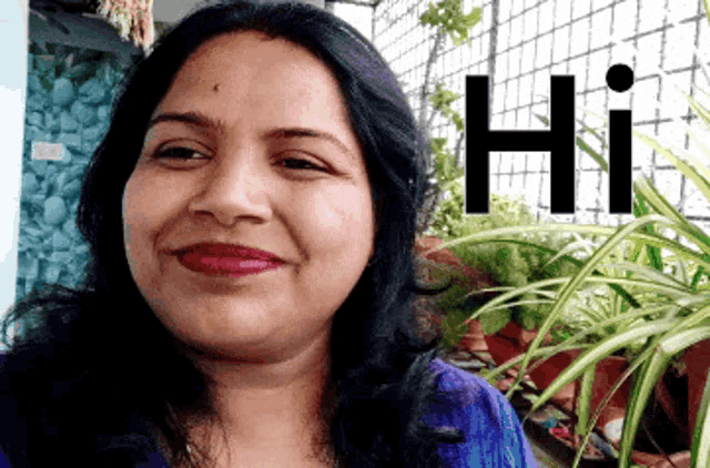 a woman is smiling in front of a sign that reads hi