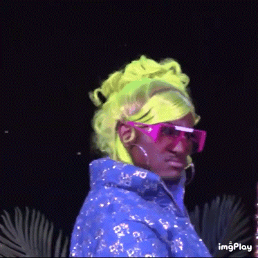 a person wearing neon green hair and pink sunglasses