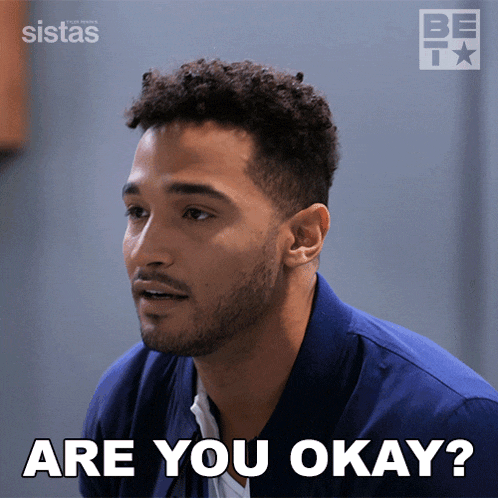 a man says " are you okay " in front of a poster for sistas